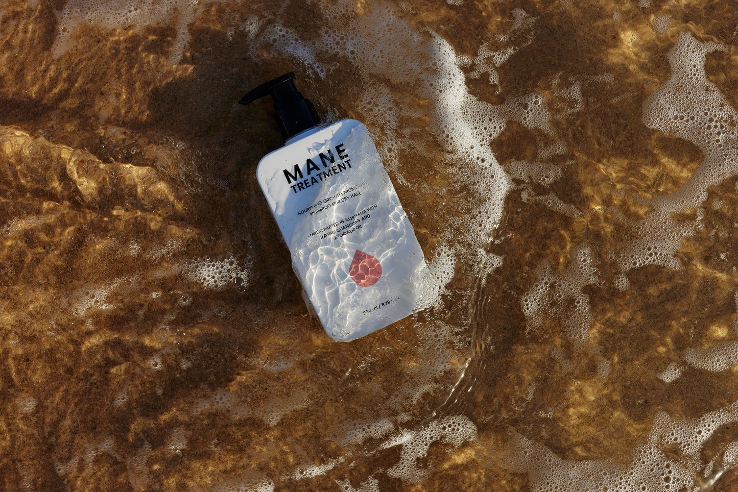 Mane Treatment nourishing, growth promoting Australian Native shampoo in water at the beach by Hub for Belle