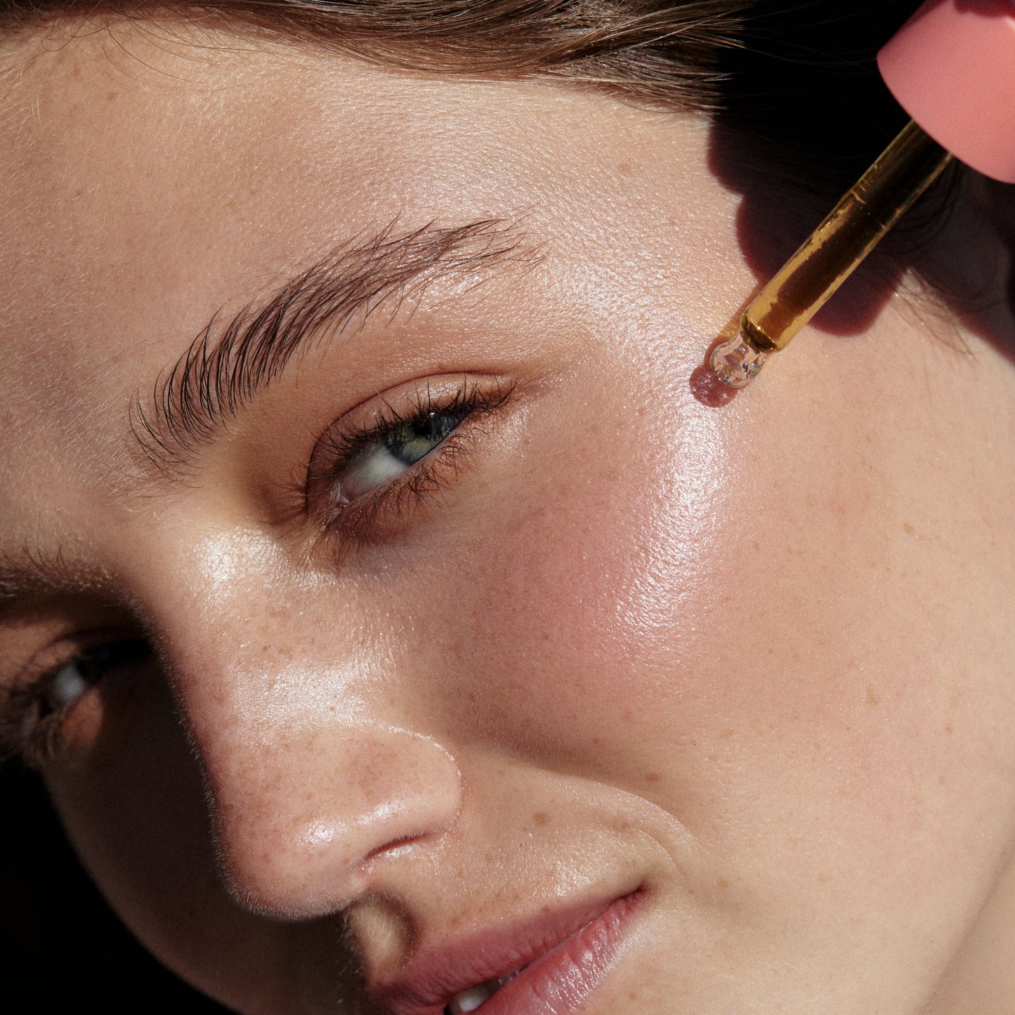 Model close up of Hydra Glow Facial oil on skin made with natural vegan Australian botanicals for glowing skin from Hub for Belle