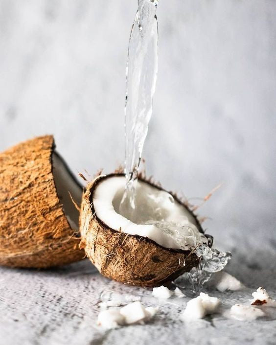 Hub for Belle Skincare, Haircare and Wellness Range Coconut Ingredient with water being poured into shell