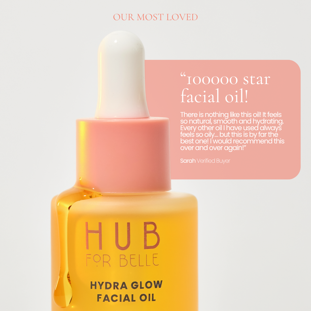 A bottle of HUB FOR BELLE Hydra Glow Facial Oil with a pink dropper cap, set against a light gray background with a pink customer review graphic. A bottle of HUB FOR BELLE award winning natural skincare Hydra Glow Facial Oil.