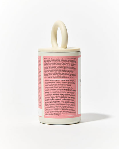 A white cylindrical container of Hub for Belle Beauty and Wellbeing Blend container 2026 Organic beauty winner with a cream-colored loop handle on top and a pink label on the back, photographed against a clean white background. List of benefits
