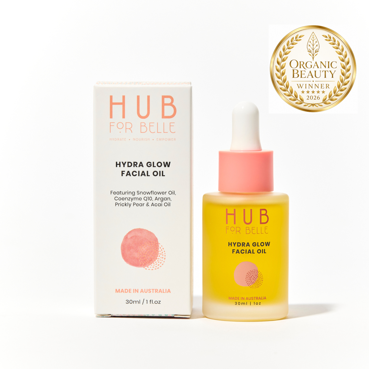Hub For Belle Hydra Glow Facial Oil bottle with dropper next to its white and pink packaging box, featuring a gold Organic Beauty Award Winner 2026 badge in the top right corner.