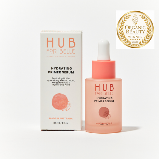 Hub For Belle Hydrating Primer Serum shown with its white and coral packaging box and a dropper bottle, alongside an Organic Beauty Winner 2026 badge on a clean white background.