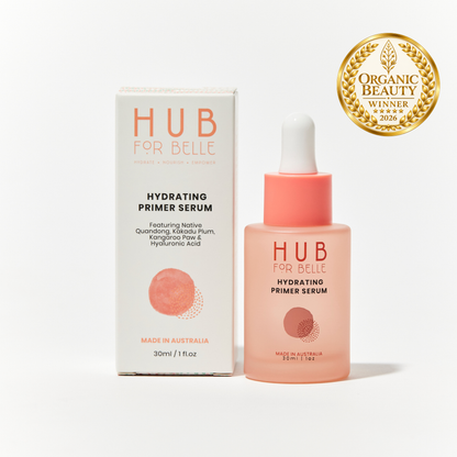 Hub For Belle Hydrating Primer Serum shown with its white and coral packaging box and a dropper bottle, alongside an Organic Beauty Winner 2026 badge on a clean white background.