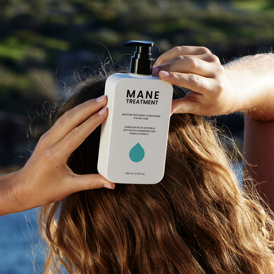 Mane Treatment moisture restoring, hair growth promoting conditioner front view held by women against the back of her hair by Hub for Belle